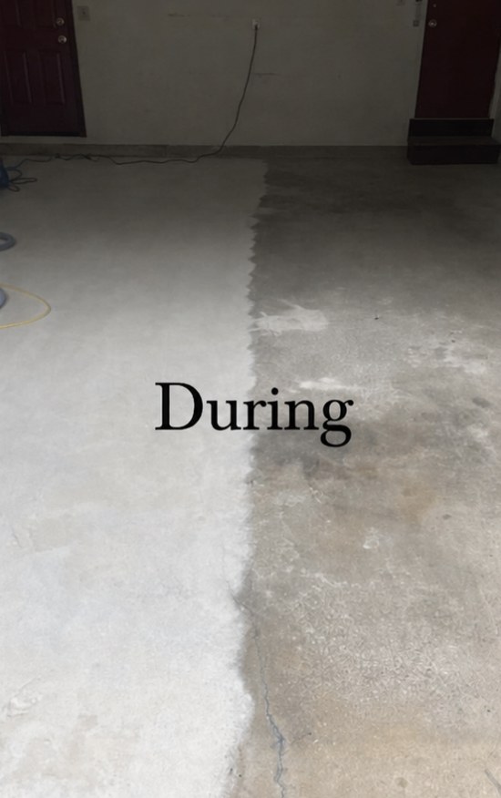 Garage floor during surface preparation — concrete grinding and cleaning in progress